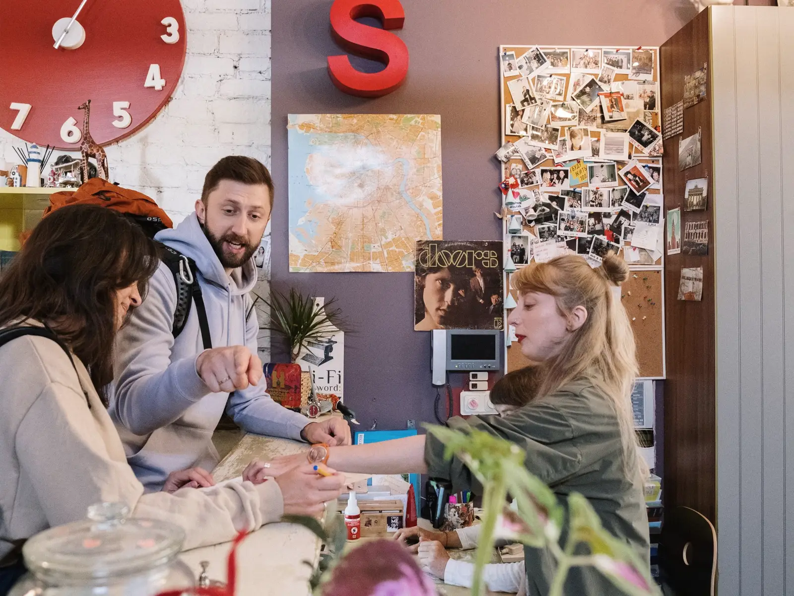 A host checking in a couple at a cosy reception desk